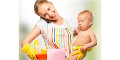Mother cleaning with her child in her arms