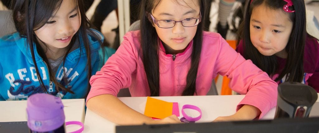 Three girls working on laptop at Girls Learning Code summer camp