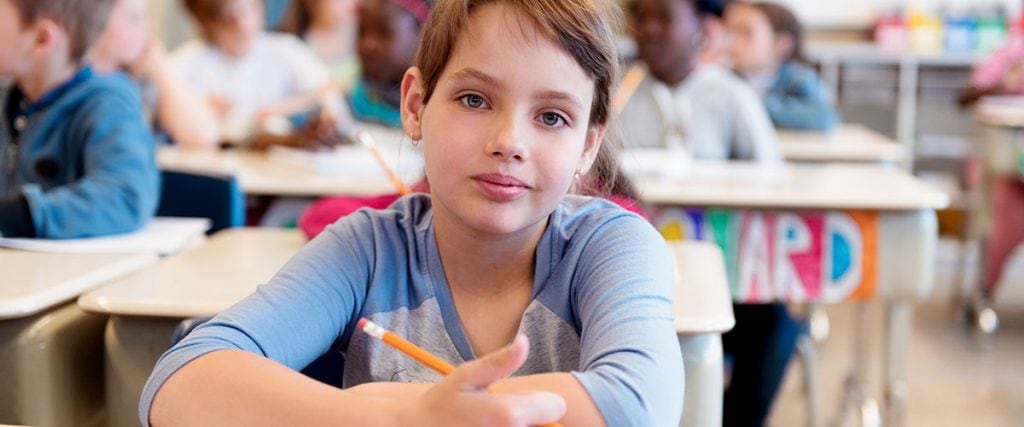 8-year-old student at her desk in school