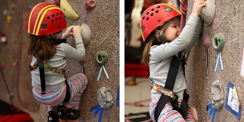 Young girl climbing indoor climbing wall