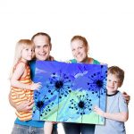 Happy family displaying their art work