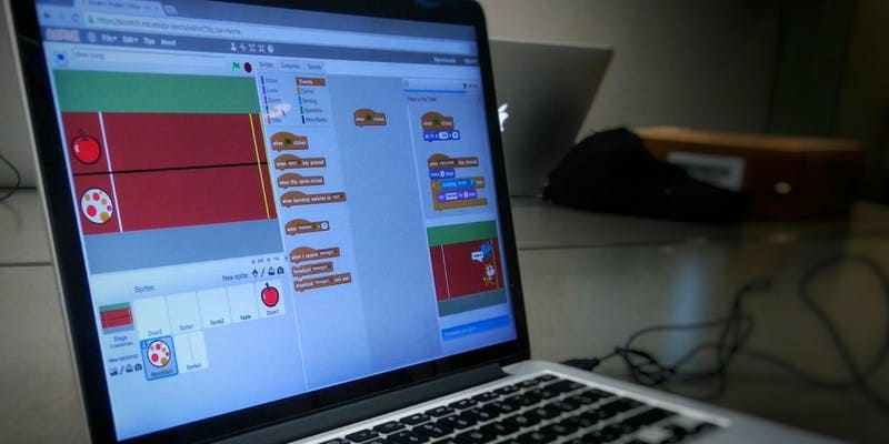laptop screen with Scratch programming