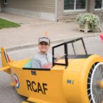 small boy in a toy RCAF plane
