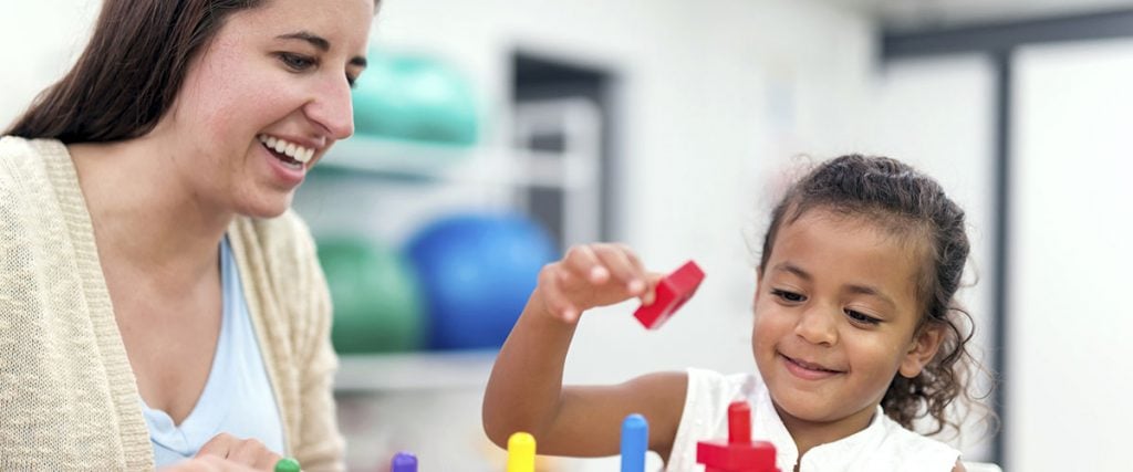 Young girl doing an exercise in a therapy session