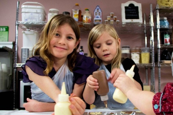 girls pouring chocolate into molds