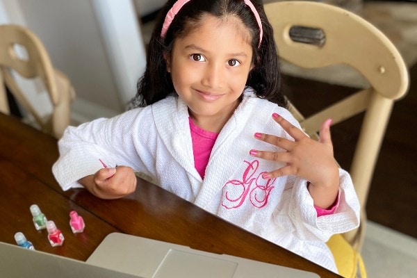 girl showing manicured nails at virtual spa party