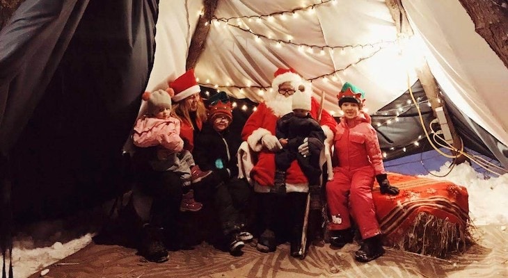 family with Santa in a traditional kota tent