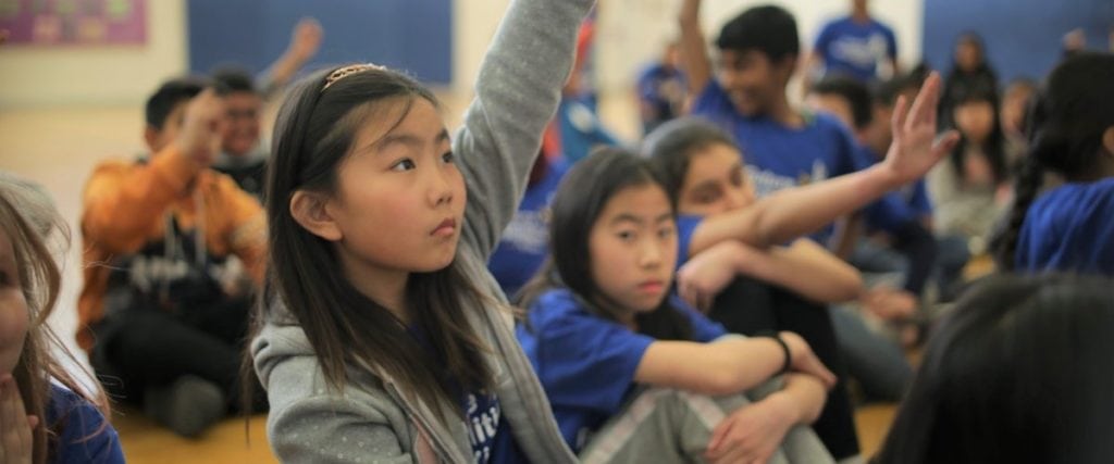 girl raising hand at a Future Possibilities for Kids event